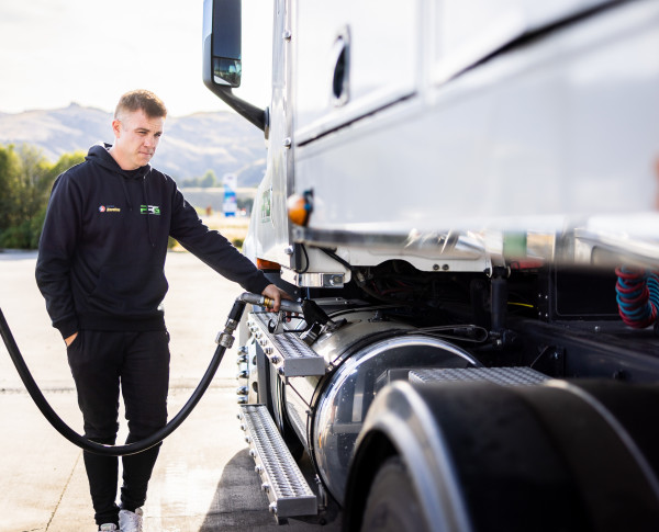 Hayden Paddon fuelling up at a truck stop wearing a Caltex hoodie